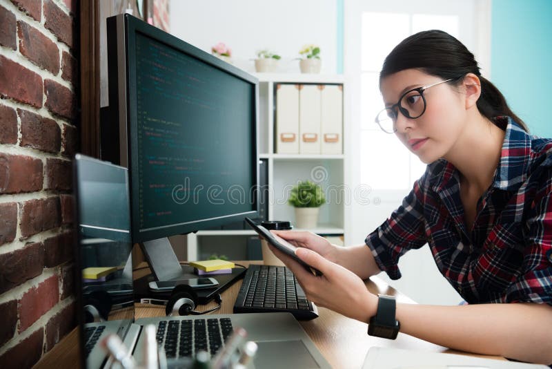 Attractive female programmer using mobile pad stock photo
