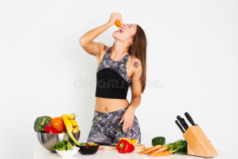 Attractive fitness woman, trained female Fit power athletic confident young woman bodybuilder eating orange, Organic Food. stock photo Attractive fitness woman, trained female Fit power athletic confident young woman bodybuilder eating orange, Organic Food. stock photo