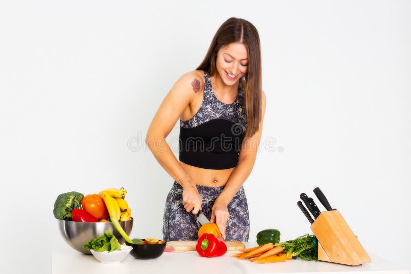 Attractive fitness woman, trained female Fit power athletic confident young woman bodybuilder cuting orange, Organic Food. stock photo Attractive fitness woman, trained female Fit power athletic confident young woman bodybuilder cuting orange, Organic Food. stock photo