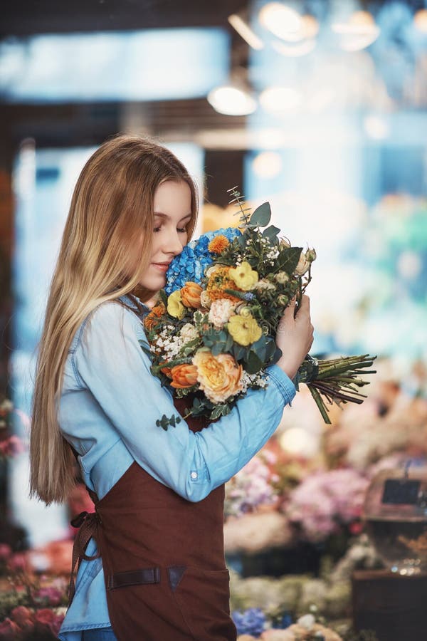 Attractive florist with a bouquet of flowers