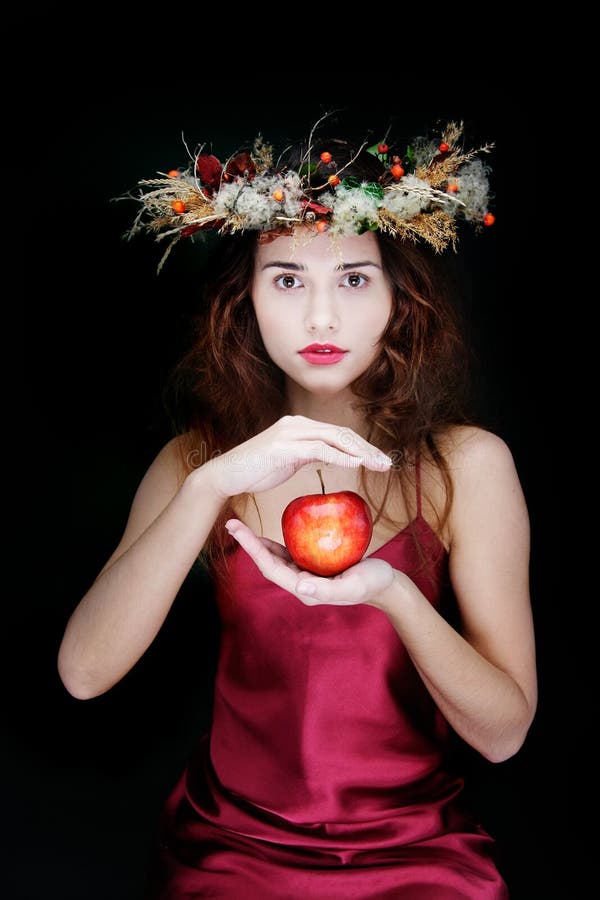 Attractive girl with apple over black