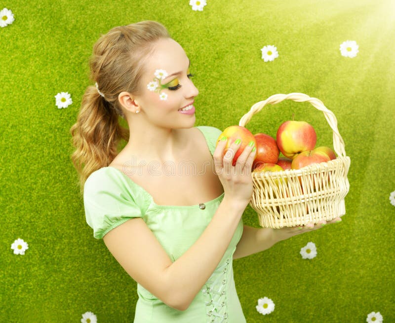 Attractive girl with basket of apples