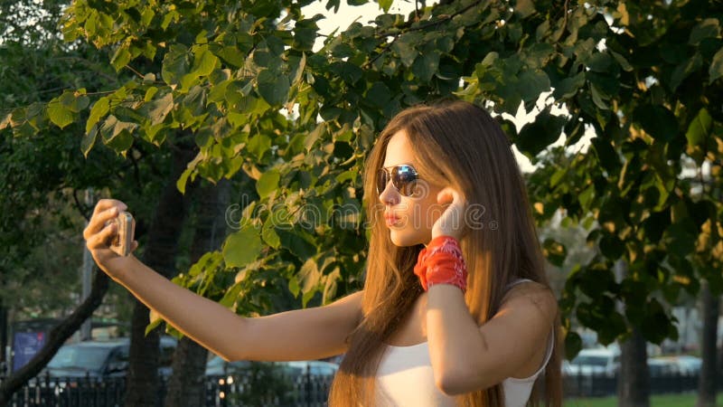 Attractive girl doing selfie smiling.