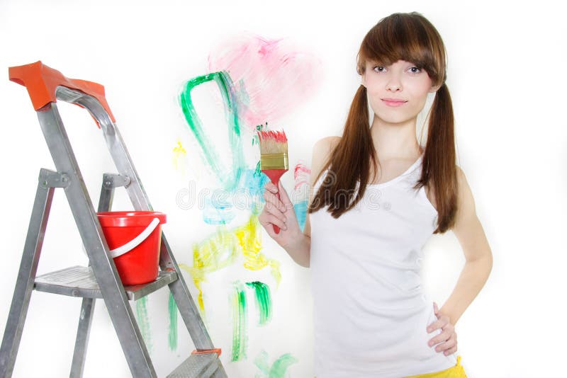 Attractive girl with paintbrush over white