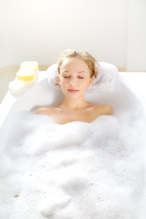 Attractive girl relaxing in bath