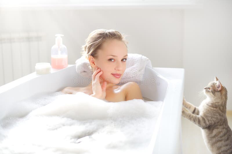 Attractive girl relaxing in bath