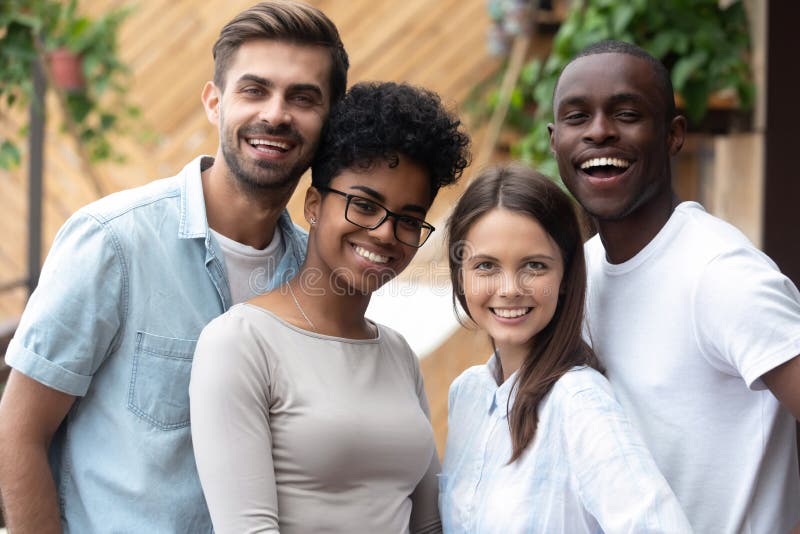 Attractive happy multiracial people posing looking at camera