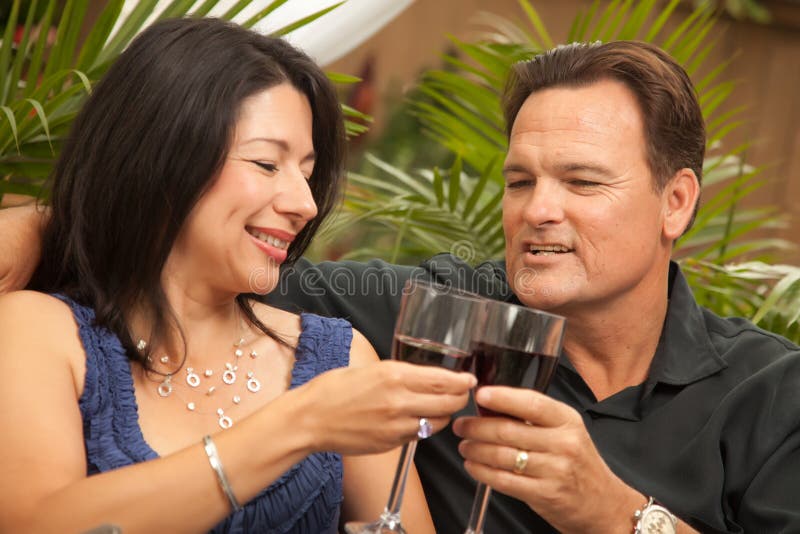 Attractive Hispanic and Caucasian Couple Drinking