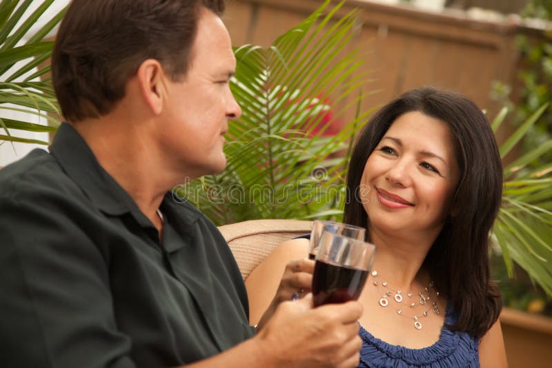 Attractive Hispanic and Caucasian Couple Drinking