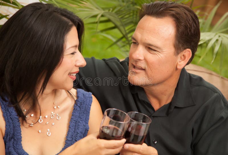 Attractive Hispanic and Caucasian Couple Drinking