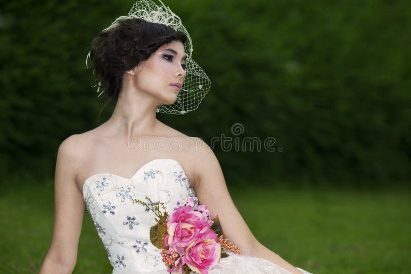 Attractive lady in formal gown in the park