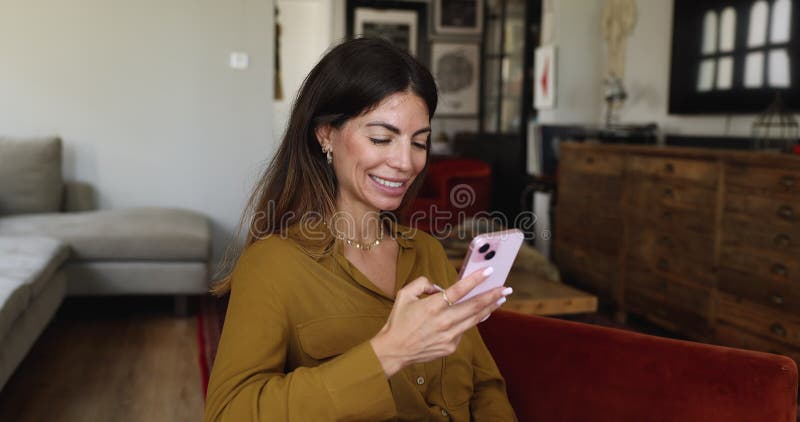 Woman speaking with friend using videocall application on smartphone stock video footage