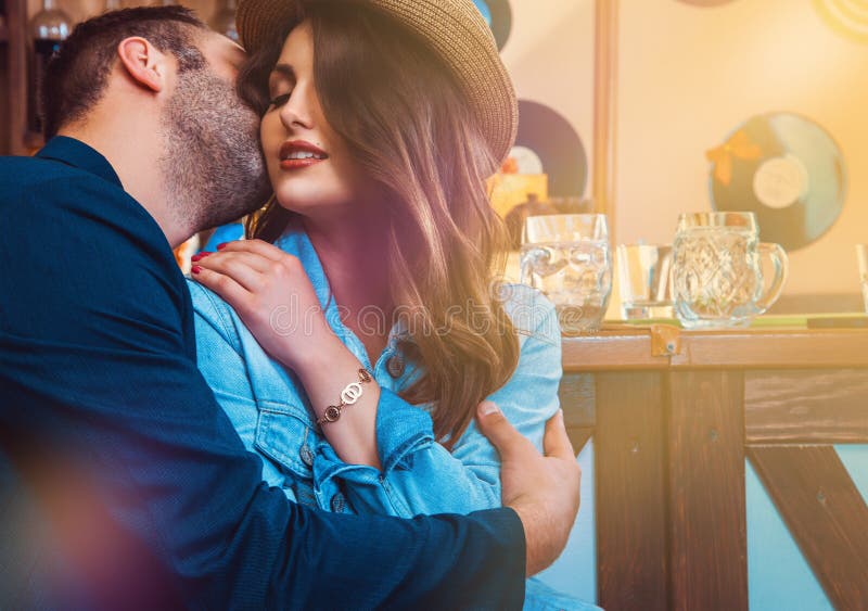 Attractive lovers kissing and hugging at bar stock photos