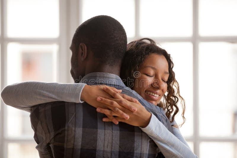 Happy Afro American girlfriend and boyfriend play games on