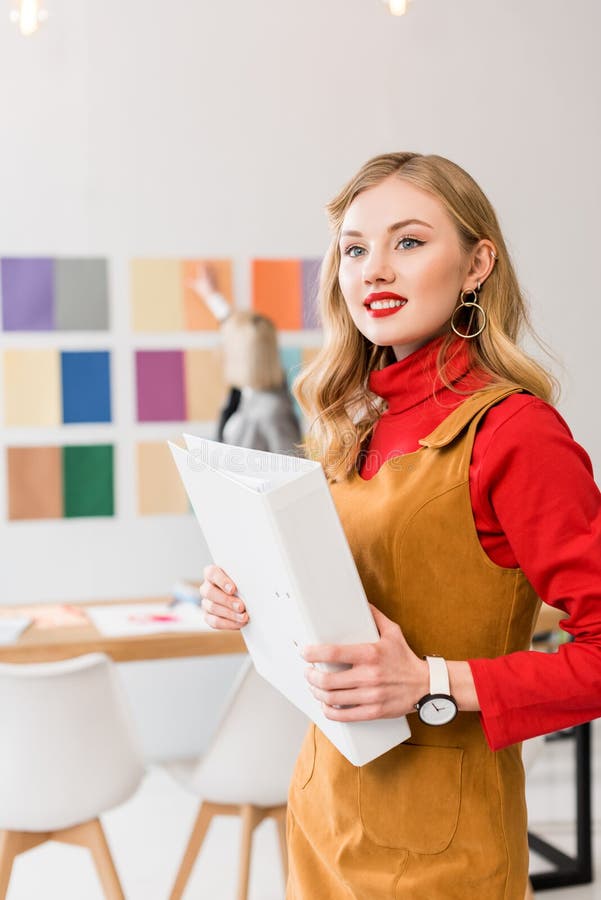 Attractive Magazine Editor  With Folder In Modern Office 