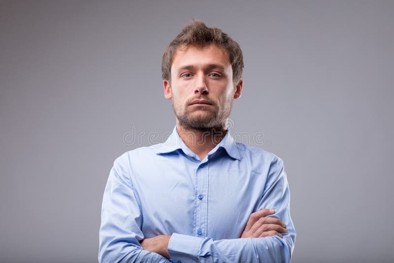Attractive man with a deadpan expression stock photos