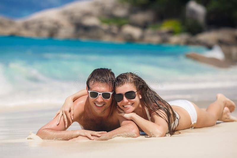 An attractive man and woman on the beach.