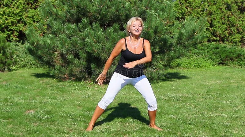 Attractive mature woman is aerobic instructor