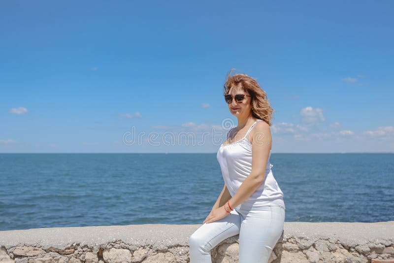 Attractive middle aged woman enjoying happy retirement with holiday at beach