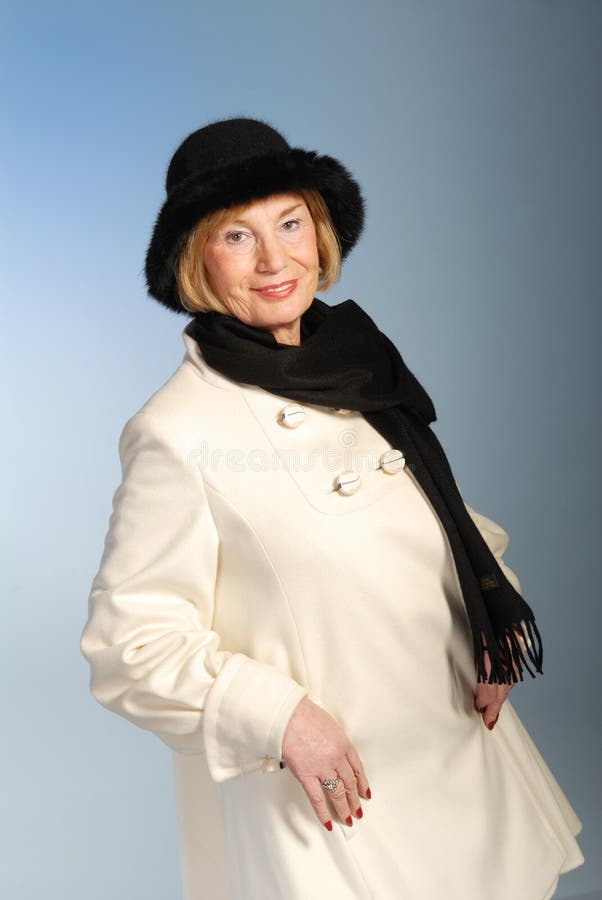 Attractive older woman in winter coat & hat