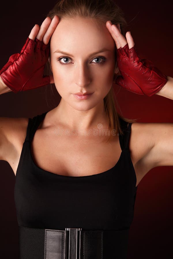 Attractive posing blonde in a red sport gloves