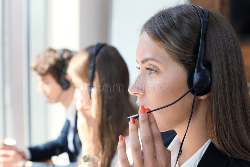 Attractive positive young businesspeople and colleagues in a call center office. royalty free stock photos Attractive positive young businesspeople and colleagues in a call center office. royalty free stock photos