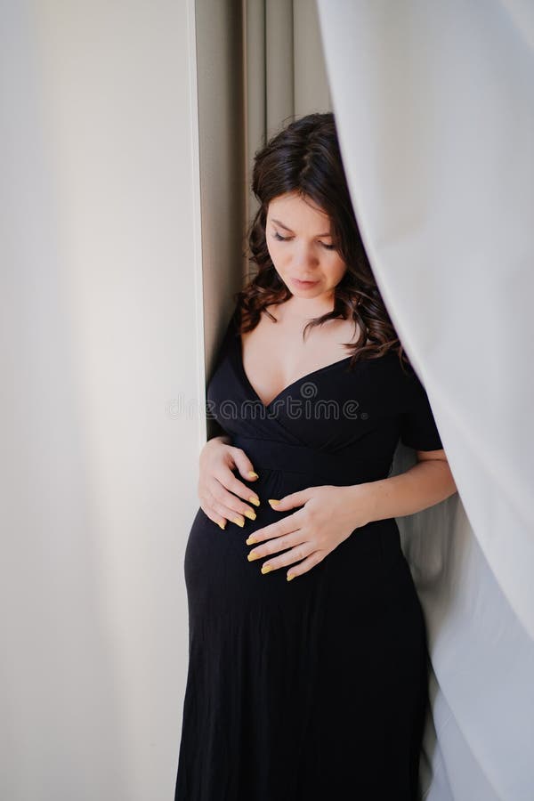 A Pregnant Woman Topless In Pajama Pants In Profile In A Home Interior.  Stock Photo, Picture and Royalty Free Image. Image 199459323.