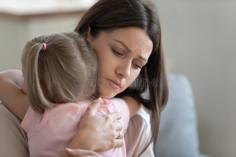 Attractive sad woman embrace little preschool frustrated daughter