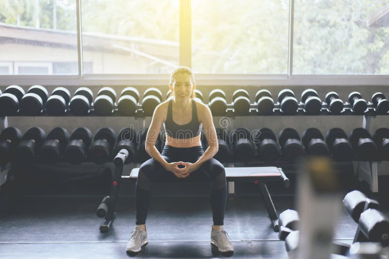 Attractive slim woman sitting at gym in the morning,Asian female break and relax after workout stock photos Attractive slim woman sitting at gym in the morning,Asian female break and relax after workout stock photos
