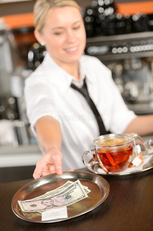 Attractive waitress taking tip in bar USD