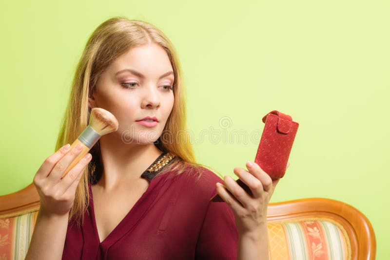 Attractive Woman Applying Make Up With Brush.