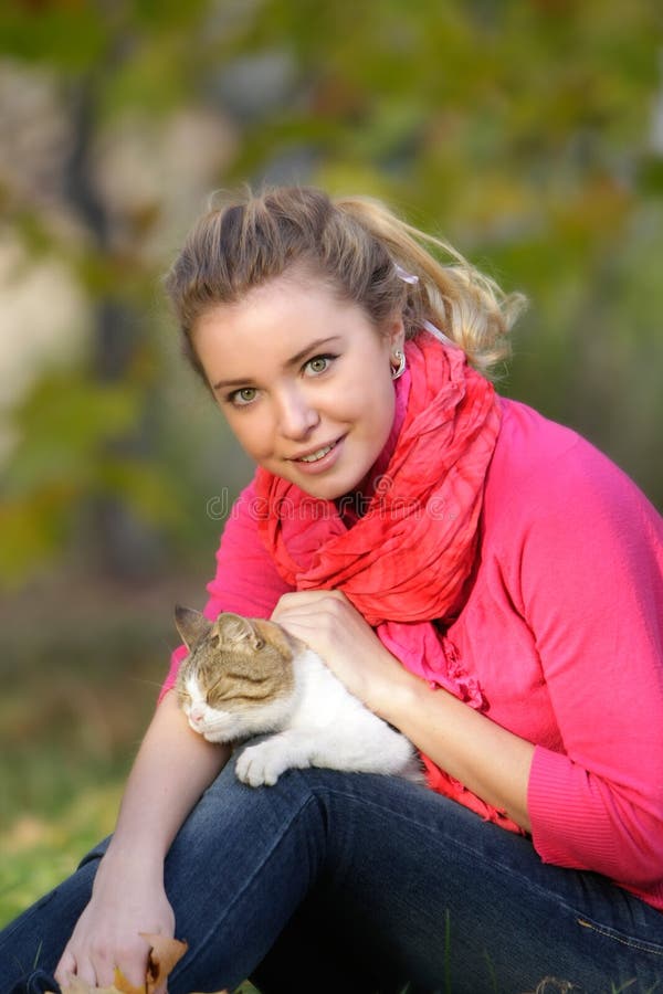 Attractive woman with cat outdoors