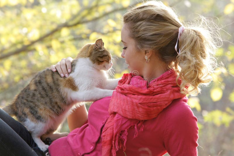 Attractive woman with cat outdoors