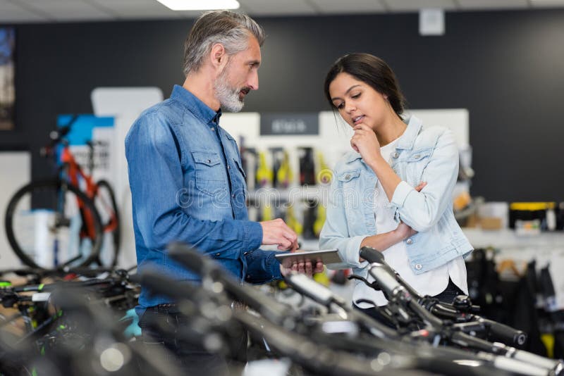 Attractive woman chooses bike in sport store royalty free stock photo Attractive woman chooses bike in sport store royalty free stock photo