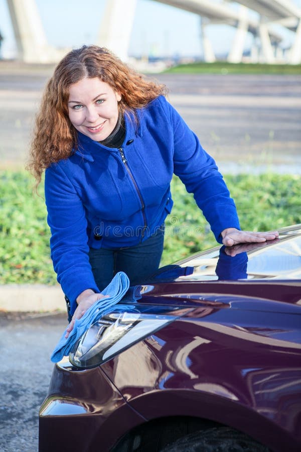 Woman polishing car cowl stock image. Image of cowl, attractive 29094177