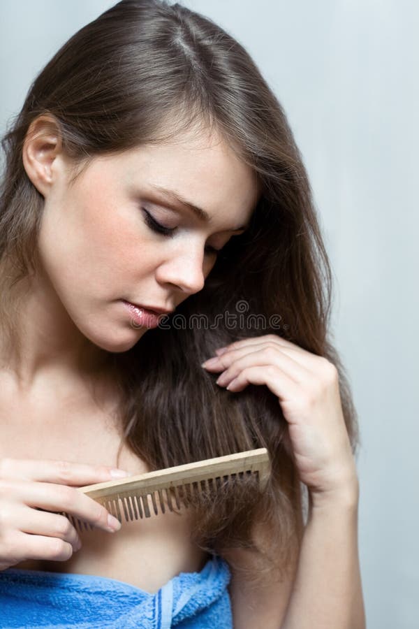 Attractive woman combing her hair