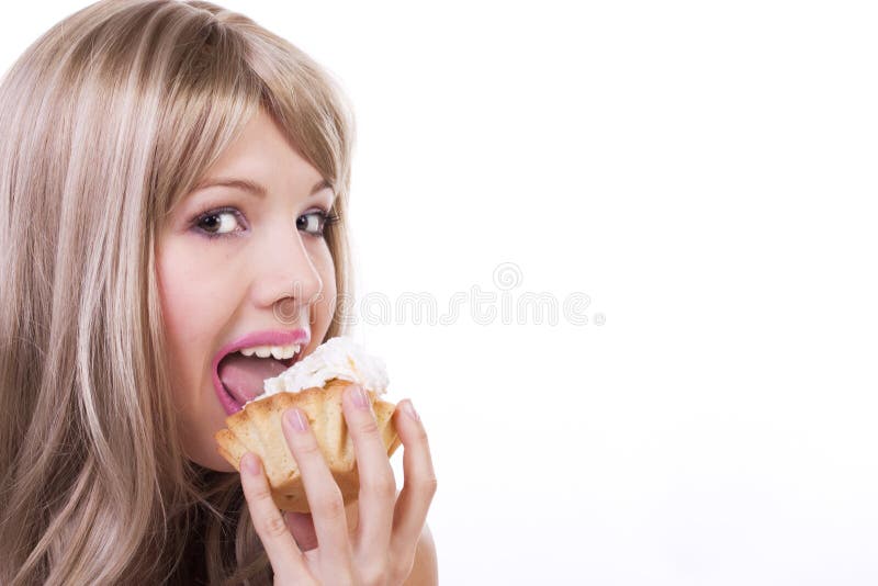 Attractive woman eating a cake. Isolated on white