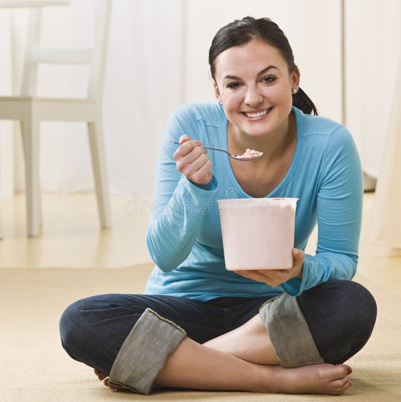 Attractive woman eating ice cream