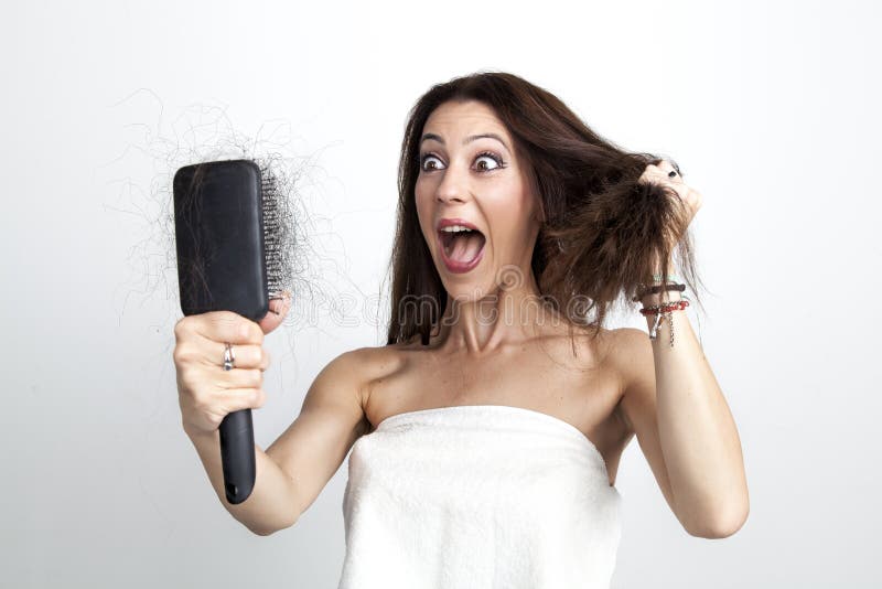 Attractive woman with hair loss tearing her hair