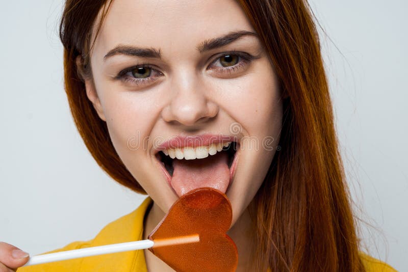 Attractive Woman Licking Heart Lollipop Close Up Studio Stock Photo Image Of Hair Carefree