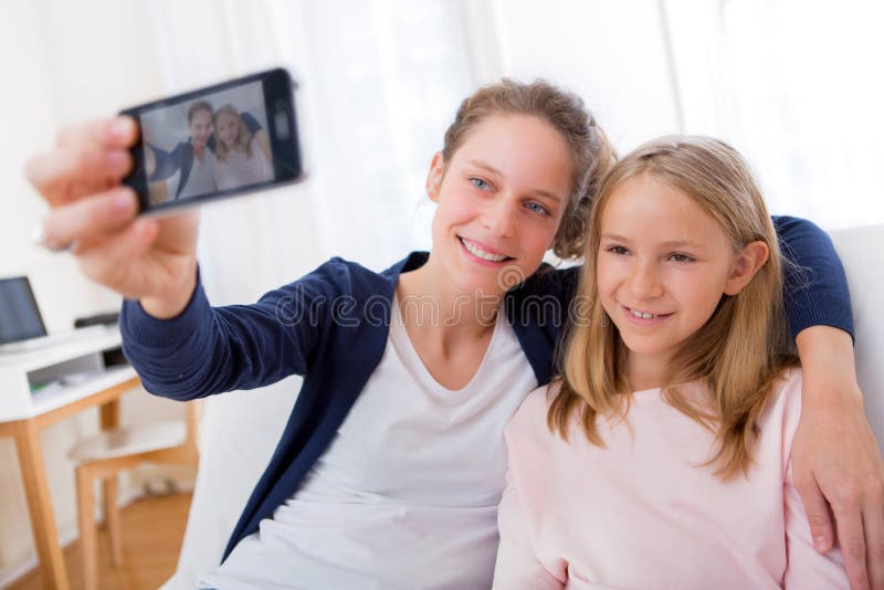 Attractive Woman and Little Sister Taking Selfie Stock Image - Image of ...