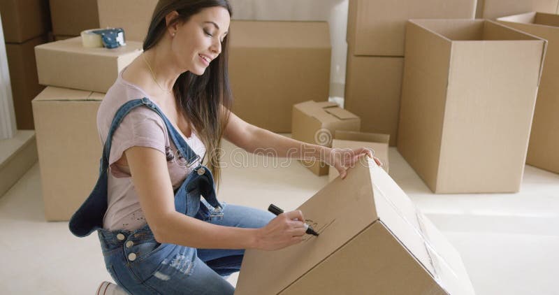 Attractive woman moving house and packing