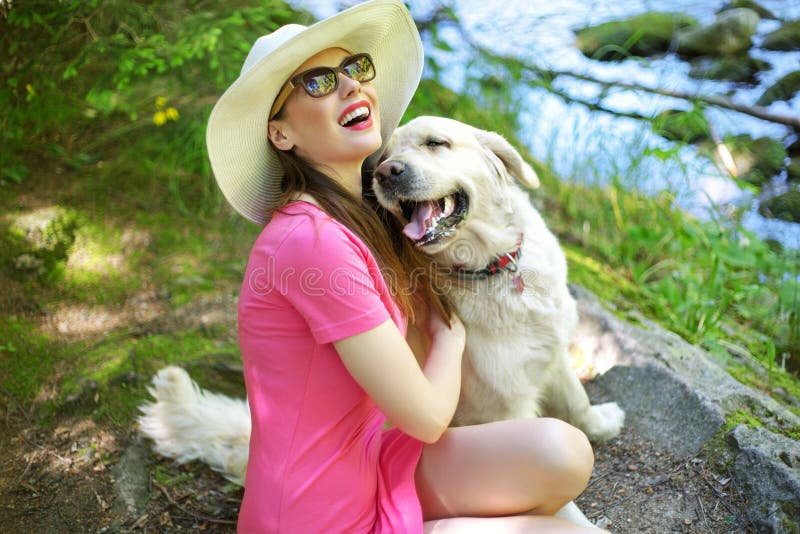 Attractive woman playing with lovely dog