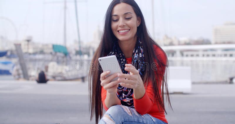 Attractive woman reading a text message