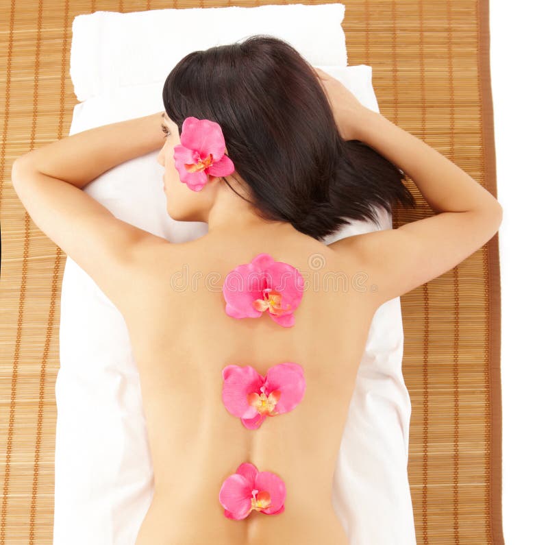 Attractive Woman Relaxing Spa with Flowers