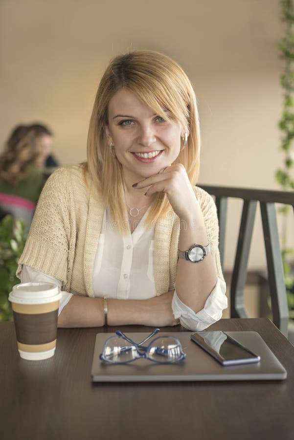 Attractive Woman in Restaurant Looking Straight at the Camera, C Stock