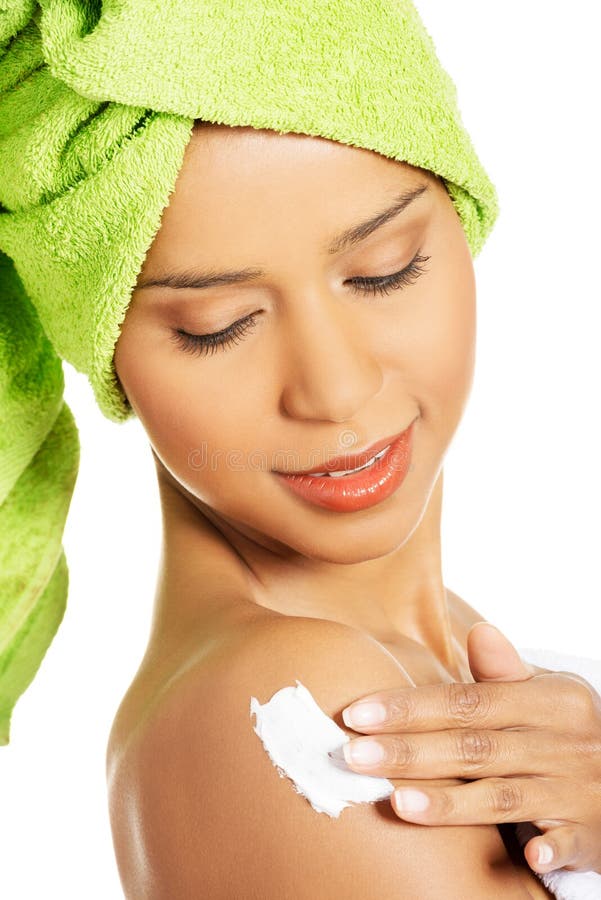 Attractive Woman Rubbing A Body Lotion On Her Arm. Side View. Royalty