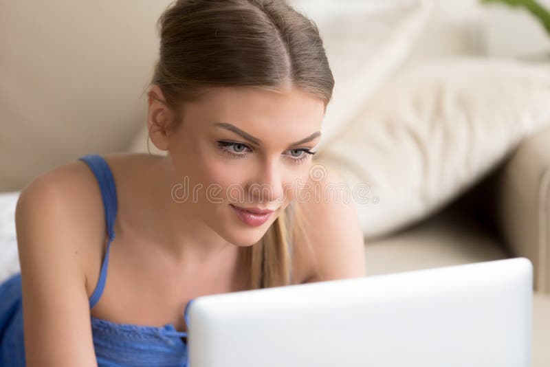 Attractive woman using laptop on sofa