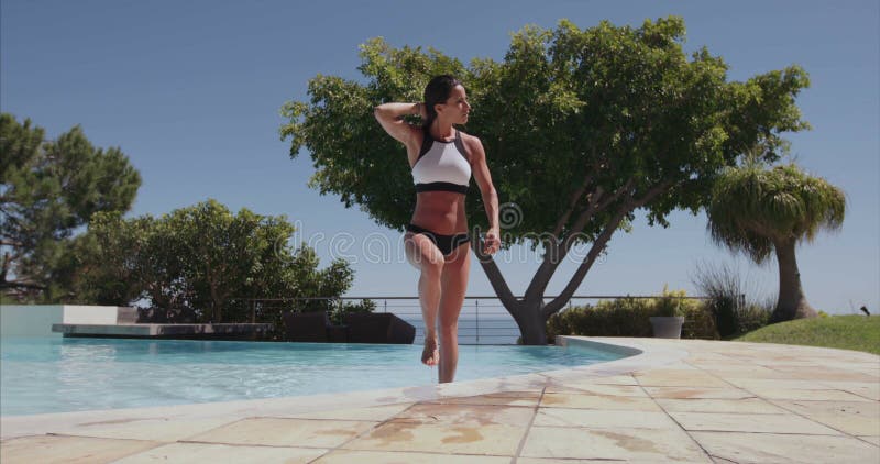 Attractive woman walking out of swimming pool