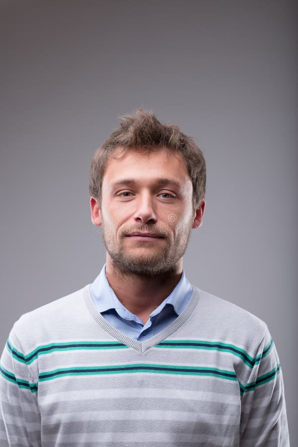 Attractive young blond man over grey royalty free stock photo